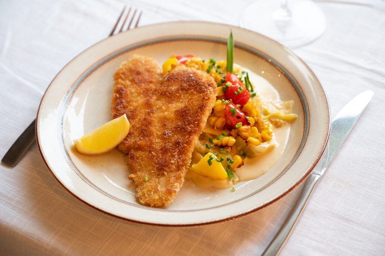 Panerad fisk med vitvinsstuvad spetskål och stekt majs